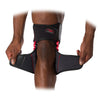 McDavid NRG Knee Over Wrap with Stays with Spring Hinges - On Model - Unwrapping Bottom Knee Wrap